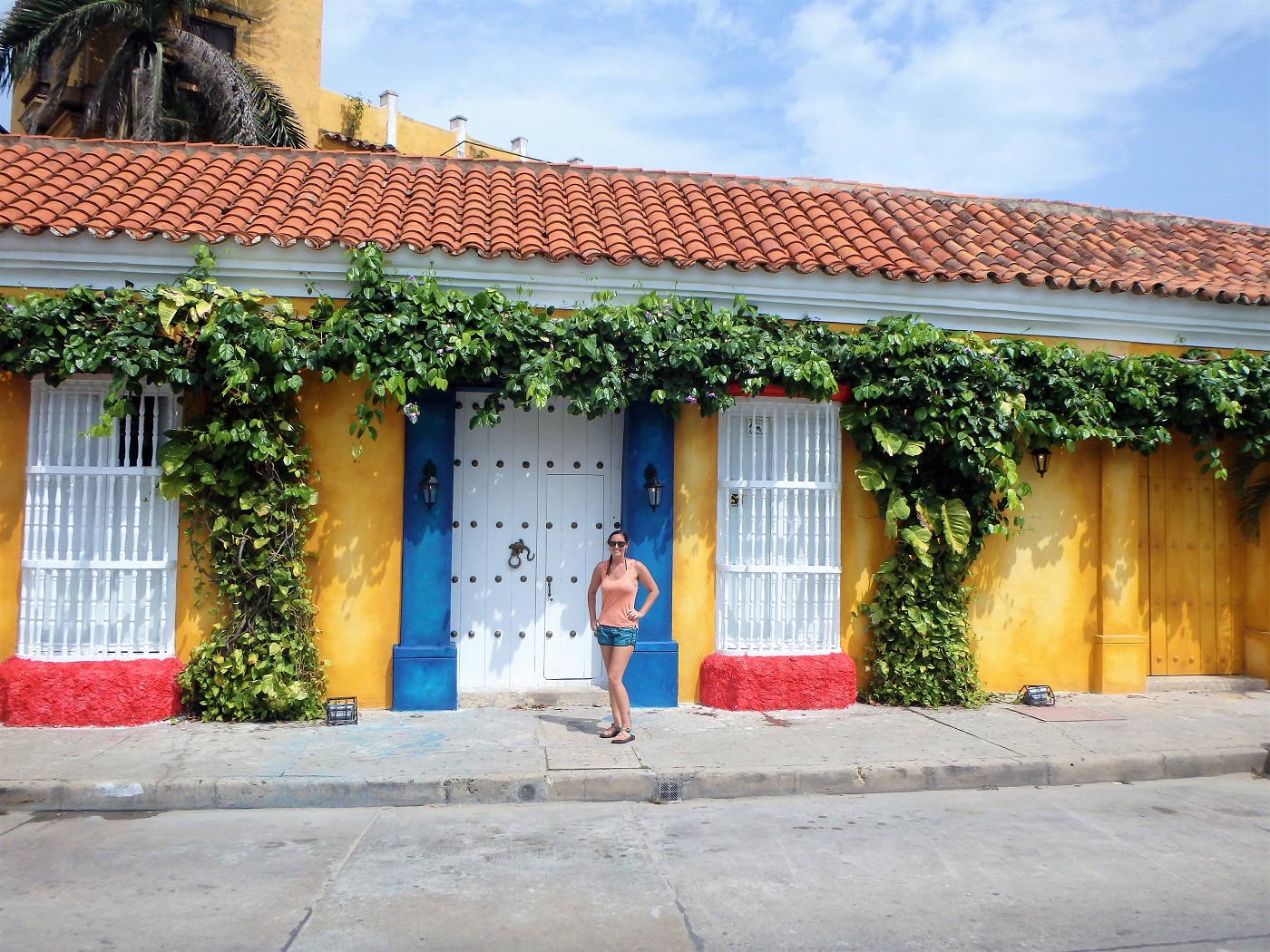 Me standing beside a colourful building within the old walled town