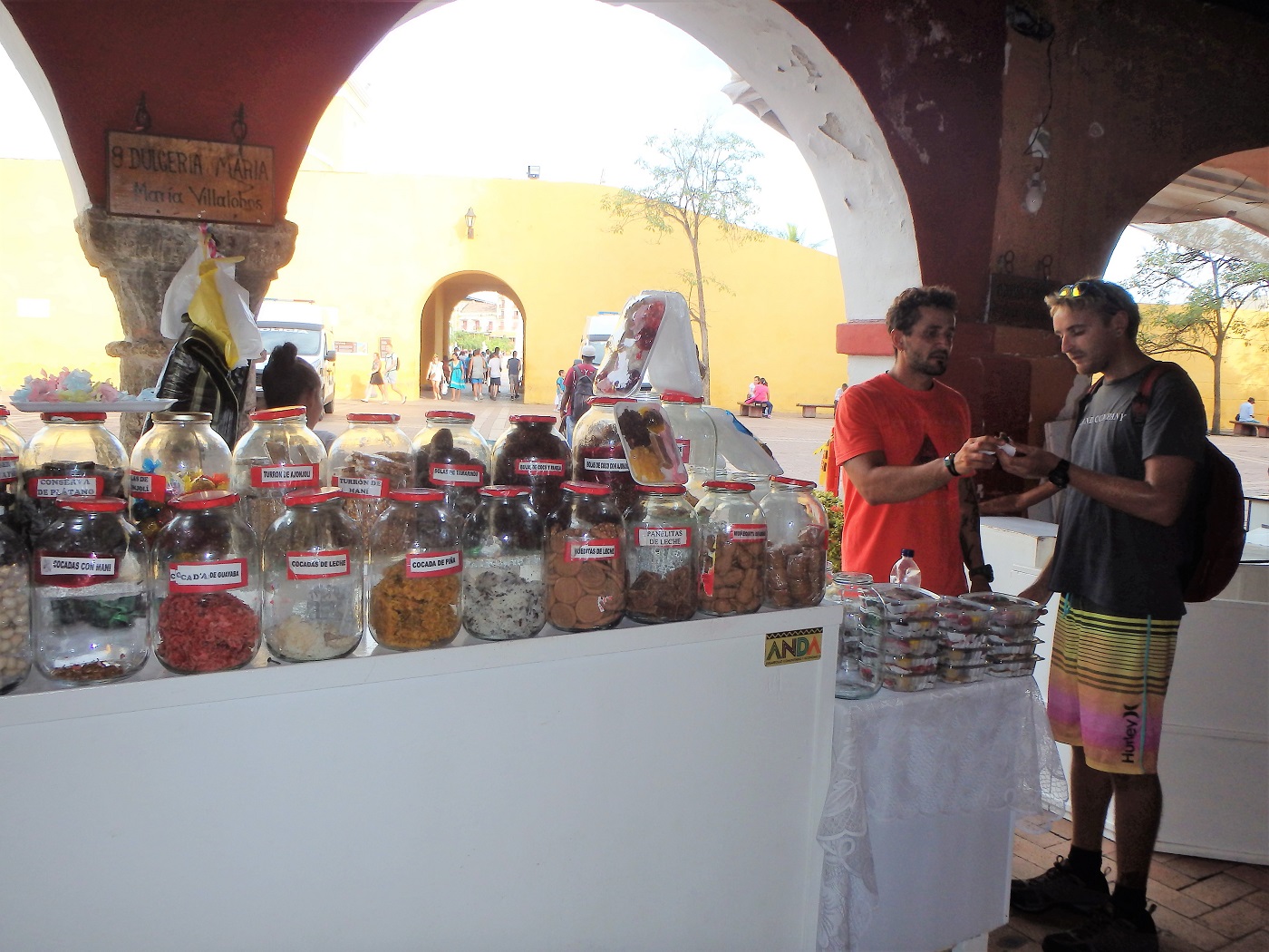 Rhys and Jorge buying sweets from a vendor