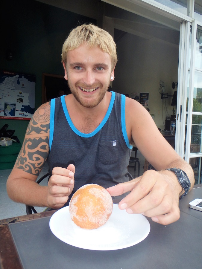 Rhys with a buñuelo from our favourite bakery next to the hostel.