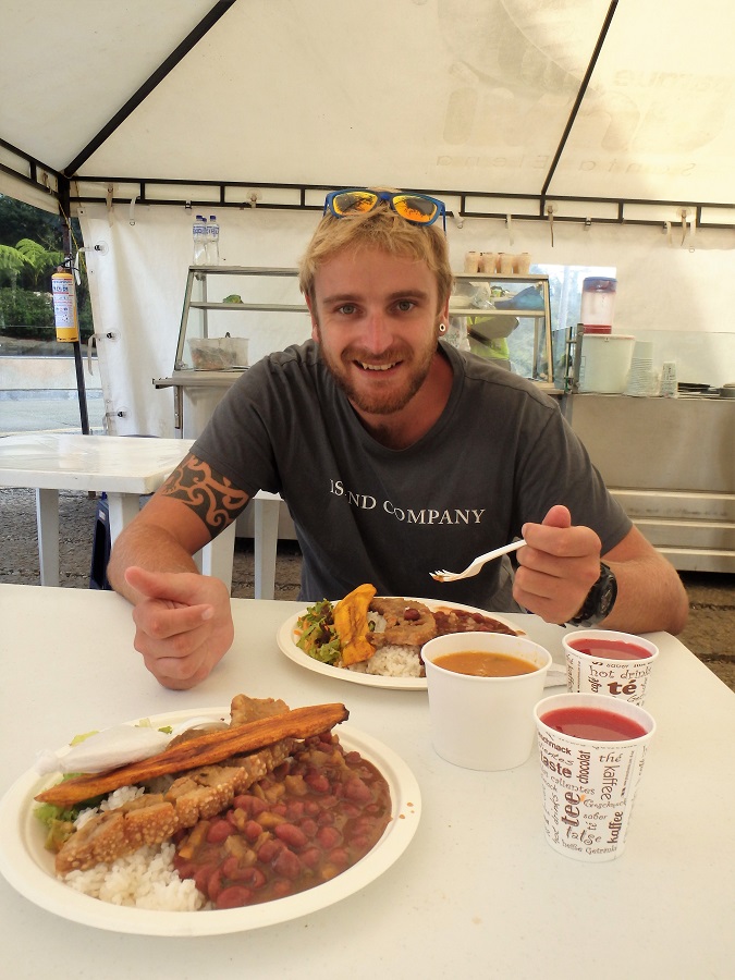 Rhys with our two massive plates of chicharrón in Parque Arvi