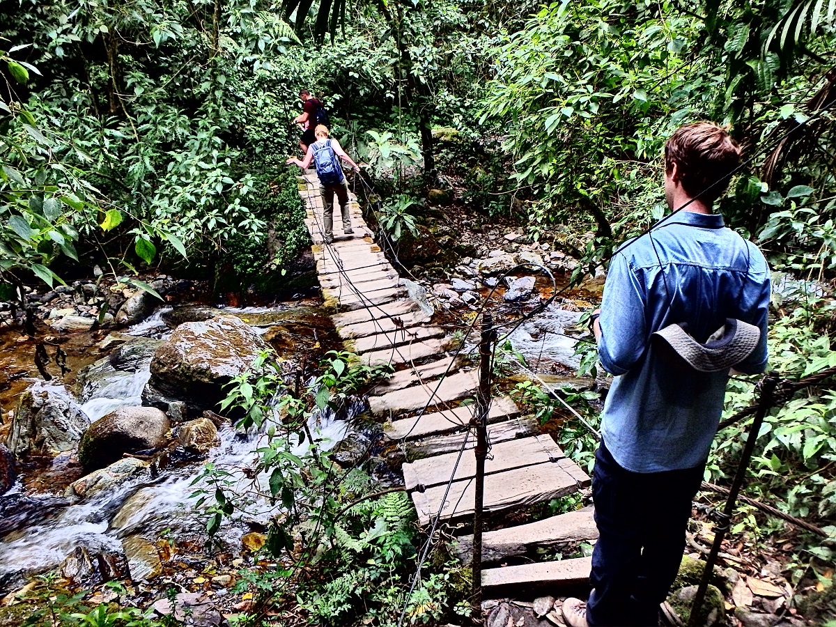 Waiting for a fellow backpacker to cross the rickety bridge over the stream