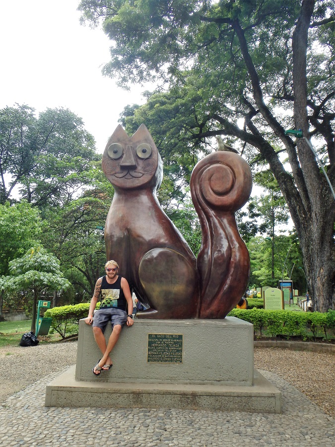 Rhys sat alongside the El Gato del Rio statue