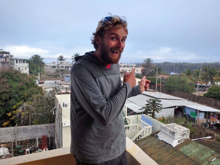 Rhys excitedly pointing to a spec of ocean over the buildings