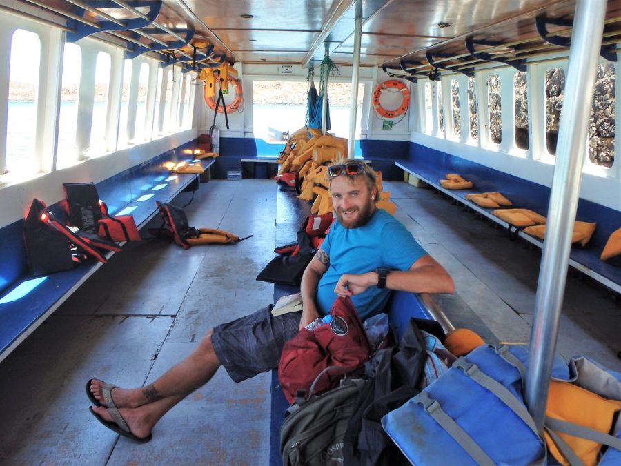 Rhys sitting alone on the seemingly large ferry across from Batlra Island