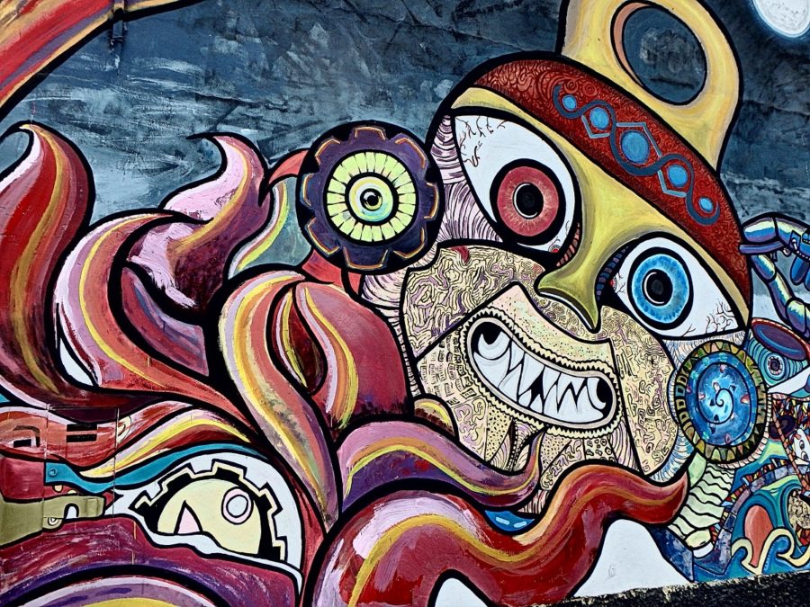 A weird and wacky mural of a colourful face