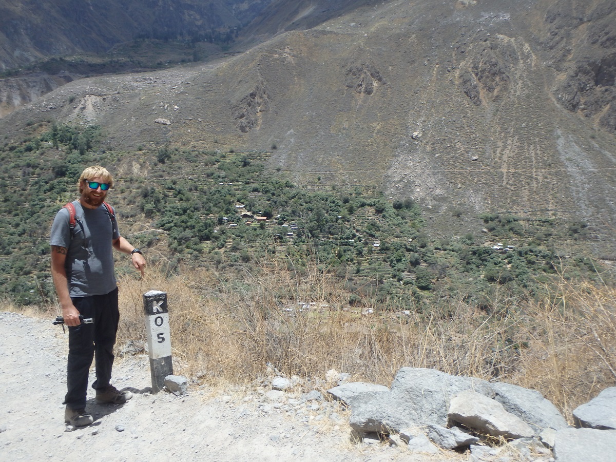 Rhys next to the 5km marker, 1km into our trek