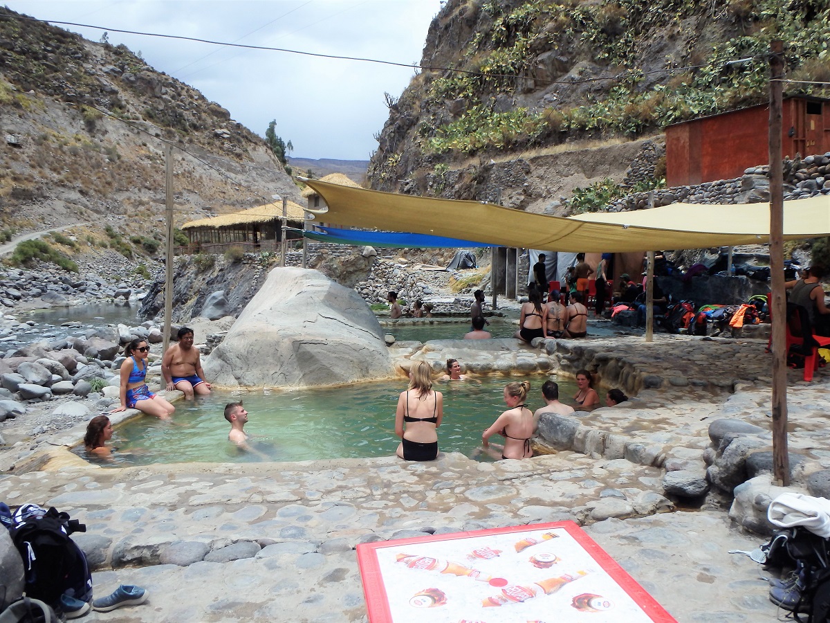 Travellers enjoying the hot springs after trekking the canyon