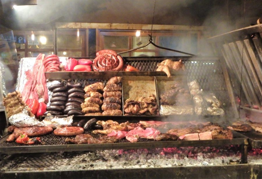 A massive grill cooking numerous meats