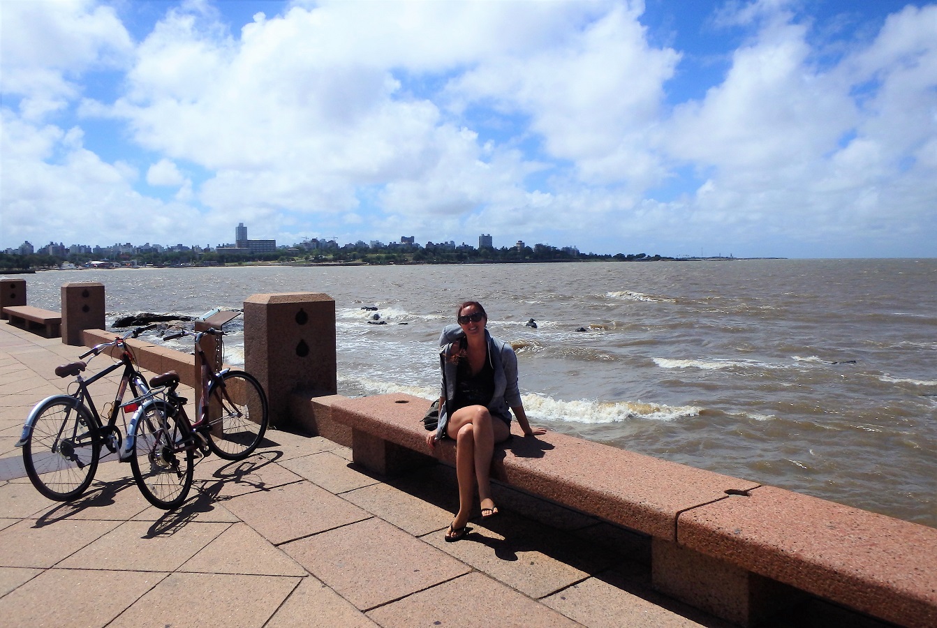 Me sitting on the malecon wall in Montevideo