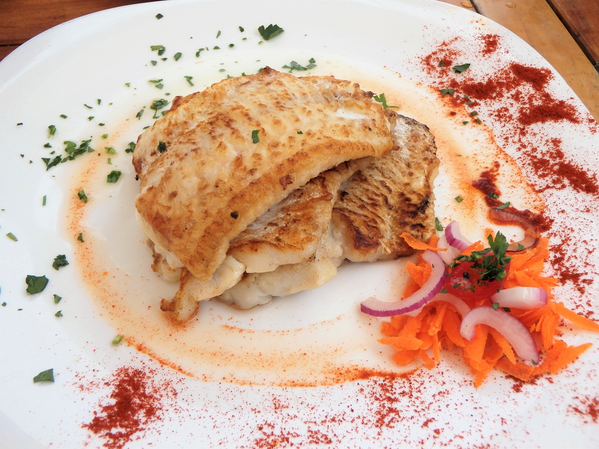 A plate stacked with several filets of fish