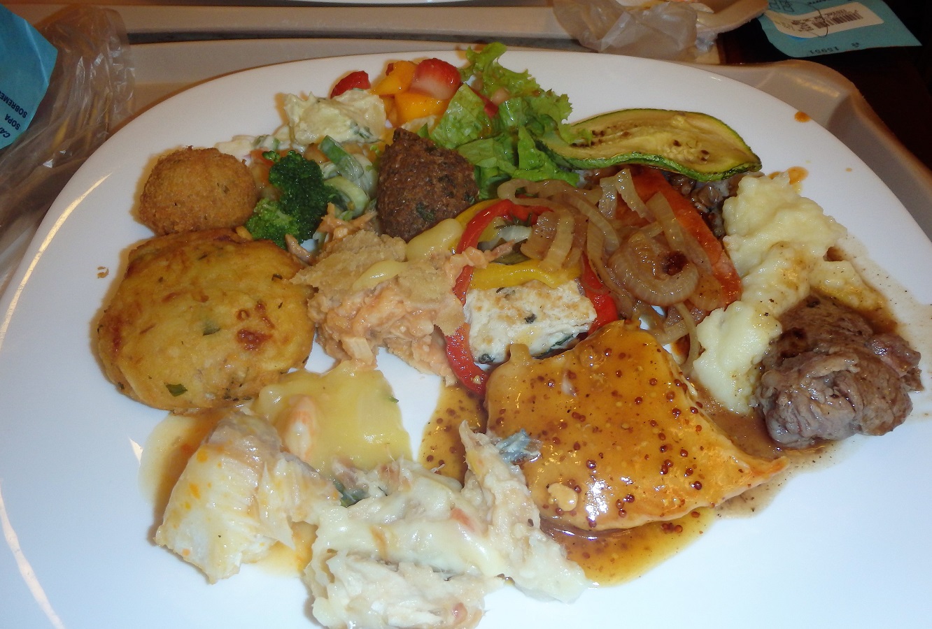 A plate piled high with various Brazilian food