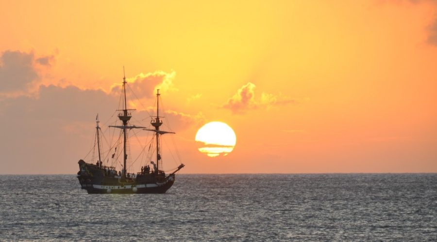 The local Jolly Roger cruising along the horizon as the sun sets.