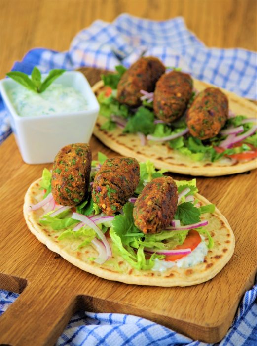 Two flatbreads with tzatziki and lentil koftas